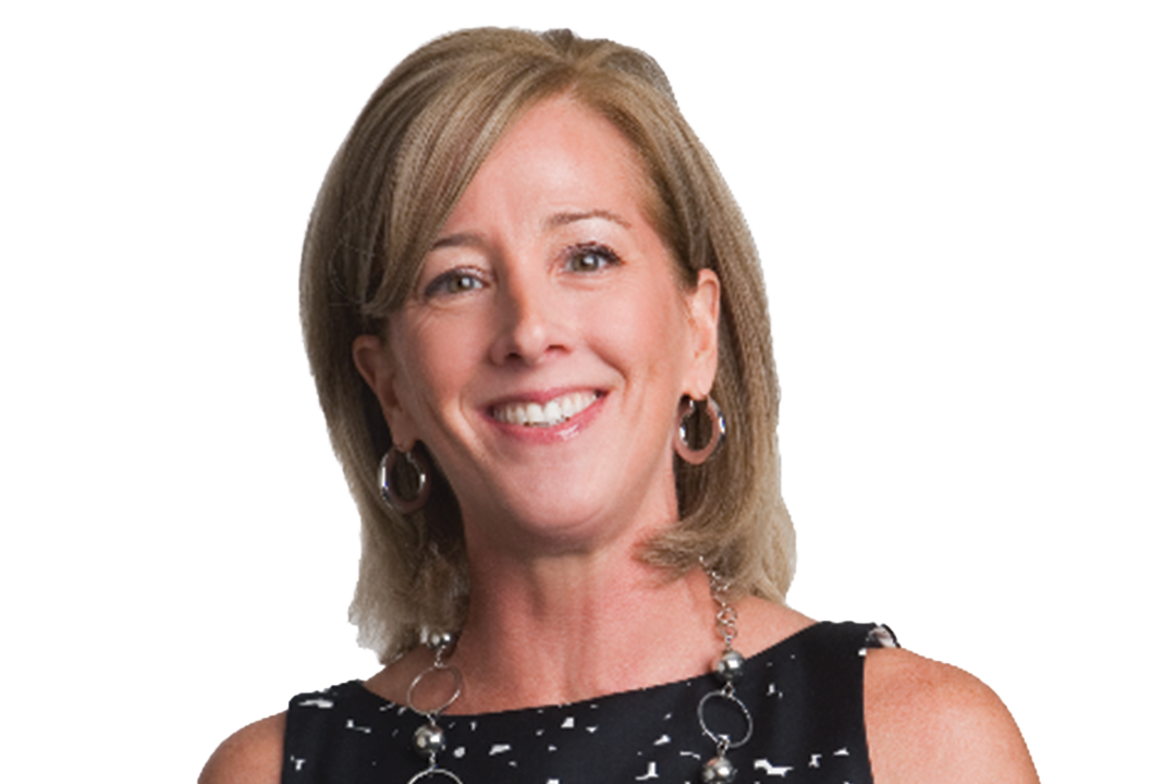 Smiling woman with short hair, wearing earrings and a black sleeveless top with a patterned neckline, against a white background